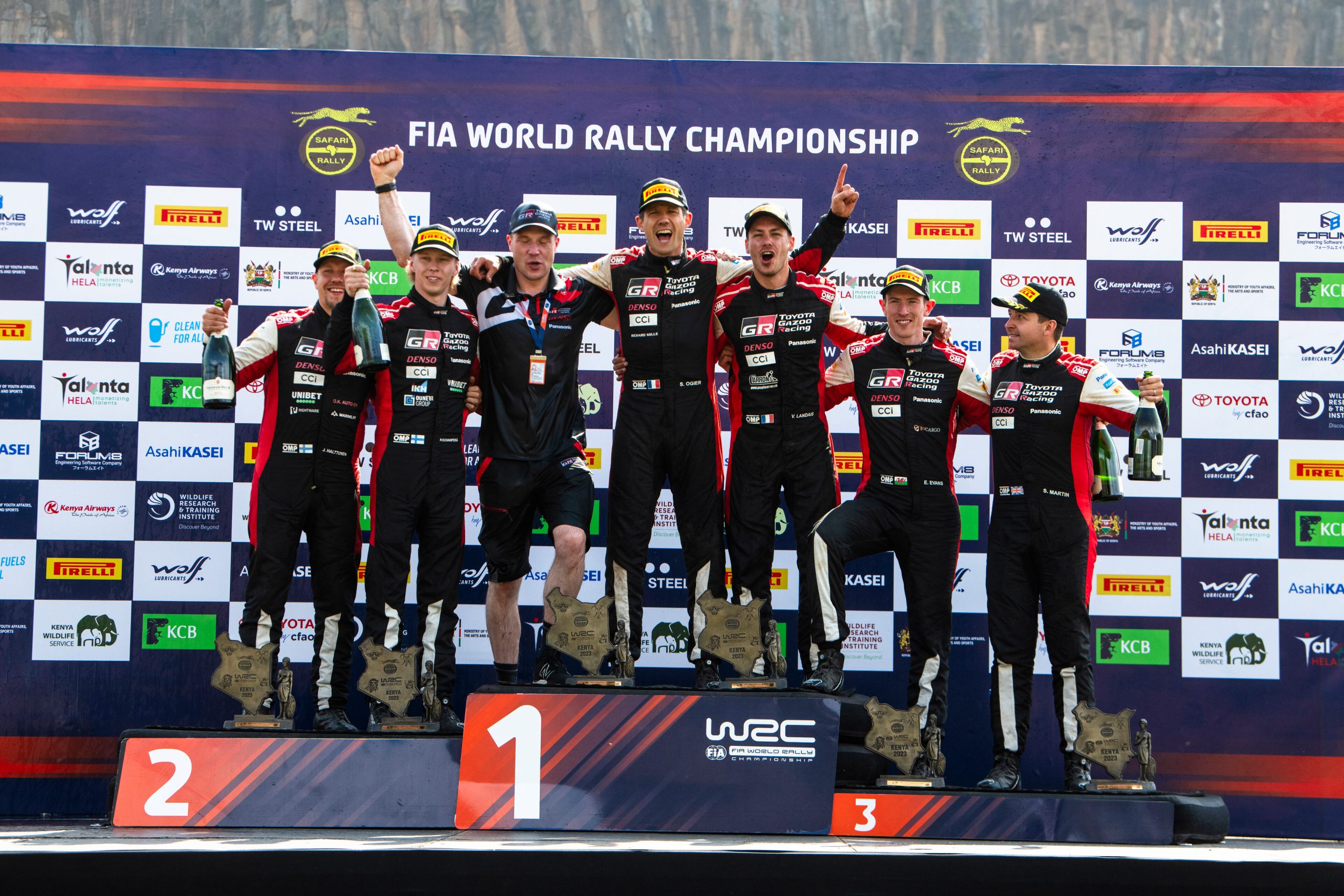 Sebastien Ogier (middle) Kalle Rovanperä (left) and Elfyn Evans (right) are seen on the podium at the end of Safari Rally Kenya